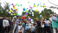 People release balloons to pray for the victims of the Japan Airlines Flight 123 crash, the world's deadliest single-aircraft accident with 520 killed, at the crash site on Mount Osutaka in Ueno Village, Gunma Prefecture on August 12, 2025. (Photo by JIJI Press / AFP) / Japan OUT