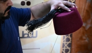 Lebanese craftsman Mohammed al-Shaar sews a tassel on a tarboosh, also known as 'fez', at his workshop in the northern Lebanese costal city of Tripoli on August 6, 2025. Photo by Joseph EID / AFP
