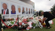 A man lays flowers and pays tribute to the victims of a military helicopter crash in Accra, Ghana, on Aug. 9, 2025. (Photo by Seth/Xinhua)

