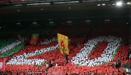 Liverpool's fans hold up cards to create a mosaic as they pay tribute to Liverpool's late Portuguese forward Diogo Jota who passed away in a car crash ahead of the English Premier League football match between Liverpool and Bournemouth at Anfield in Liverpool, north west England on August 15, 2025. (Photo by Paul Ellis / AFP)