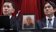 A portrait of the late Shizuo Aishima (C) is seen as his sons hold a press conference in Yokohama on August 25, 2025. (Photo by Japan Pool / JIJI PRESS / AFP) 