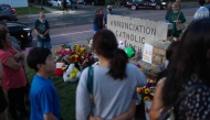 People gather at a memorial for victims of yesterday's shooting in front of Annunciation Catholic Church on August 28, 2025 in Minneapolis, Minnesota. Photo by SCOTT OLSON / GETTY IMAGES NORTH AMERICA / Getty Images via AFP