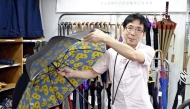 Hirofumi Kawaguchi shows a Silent Umbrella at Maruyasu Yougasa in Abeno Ward, Osaka. Pic: The Japan News
 