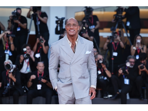 Dwayne Johnson poses at the red carpet before the premiere of the film 