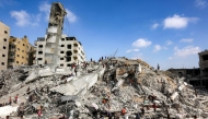 People search for salvage at the mound of rubble at the site of the collapsed Sussi Tower, which was destroyed earlier by Israeli bombardment, in Gaza City on September 6, 2025. (Photo by Omar Al-Qattaa / AFP)