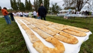 Seven rows of strudel on a table, during an attempt to set a Guinness World Record for the largest strudel in the world, in the village of Jeskovo near Karlovac, on September 6, 2025. Photo by DAMIR SENCAR / AFP