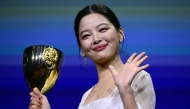 Chinese actress Xin Zhilei poses with the Coppa Volpi for Best Actress she received for her part in 