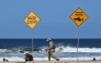 Residents walks along the shoreline as northern Sydney beaches are closed following a suspected shark attack at Long Reef Beach on September 6, 2025. (Photo by Saeed Khan / AFP)