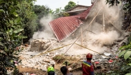 Rescue teams pull down unstable remains of a community Islamic study hall building with ropes after it collapsed while female Muslims were conducting studies in Bogor, West Java, on September 7, 2025. Photo by ADITYA AJI / AFP