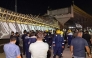 First responders and onlookers gather in front of a bridge under construction, after a section of it collapsed, killing two people and injuring others, in Karbala in southern Iraq late on September 6, 2025. Photo by Salman AMIN / AFP