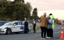 Police officers and locals stand near a roadblock where a police shootout occurred near the town of Piopio, located in New Zealand痴 Waikato region on September 8, 2025. Photo by DJ MILLS / AFP