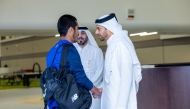 Aspire Academy officials welcome a student.