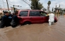 Firefighters and a member of the National Guard assist a driver stranded in floodwater after heavy rains caused the Arroyo Seco River to overflow in Tlajomulco de Zٌْiga, Jalisco, Mexico, on September 9, 2025. (Photo by ULISES RUIZ / AFP)

