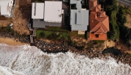 (Files) An aerial file photo taken on July 28, 2020 shows homes perched on Australia's eastern coastal town of Wamberal. (Photo by Peter Parks / AFP)