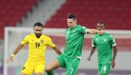 Al Ahli's Julian Draxler (centre) and Al Khaldiya's Komail Al-Aswad fight for the ball.