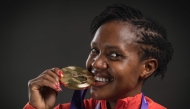 Gold medallist in the women's 1500m final Kenya's athlete Faith Kipyegon poses for portraits during a studio photo session on the sidelines of the World Athletics Championships in Tokyo on September 17, 2025. (Photo by Andrej Isakovic / AFP)