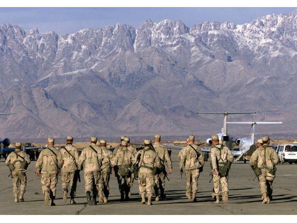 (Files) In this file photo taken on January 15, 2002, American soldiers approach the United Nations planes on the tarmac of the Bagram airbase in Bagram. (Photo by Jimin Lai / AFP)
