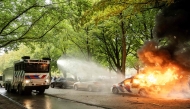 A police car is set on fire during the 