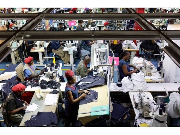 Workers operate sewing machines to stitch pieces of fabric together to make jeans inside the United Aryan textile factory at the Export Processing Zone (EPZ) in Nairobi on February 4, 2025. (Photo by Simon Maina / AFP)
