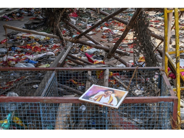 A portrait of actor-turned-politician Vijay is seen near the scattered shoes following a stampede during his political rally in the Karur district, on September 28, 2025. (Photo by AFP)