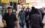 Iranians walk along a busy street in Tehran on September 28, 2025. (Photo by Atta Kenare / AFP)