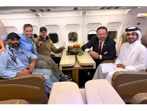 According to AFP, this handout picture released by Qatar's Ministry of Foreign Affairs (MoFA) shows Amir Amiri (left), along with US and Qatar officials. The group was onboard an aircraft following Amiri's release from detention in Kabul, Afghanistan. (Photo by AFP through MoFA handout)



