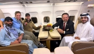 According to AFP, this handout picture released by Qatar's Ministry of Foreign Affairs (MoFA) shows Amir Amiri (left), along with US and Qatar officials. The group was onboard an aircraft following Amiri's release from detention in Kabul, Afghanistan. (Photo by AFP through MoFA handout)



