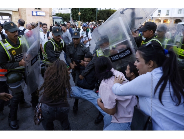 Members of the security forces detain a protester as others scuffle during a youth-led demonstration in Rabat on September 29, 2025, calling for reforms in the public health and education sectors. Dozens of youths were detained on September 29 in Morocco on the third day of protests calling for education and public health reforms, according to a local rights group and AFP reporters. (Photo by Abdel Majid Bziouat / AFP)
