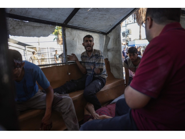 Palestinians transport casualties of a reported Israeli drone attack in Deir al-Balah, to Al-Aqsa Martyrs Hospital in the central Gaza Strip on October 2, 2025. (Photo by BASHAR TALEB / AFP)
