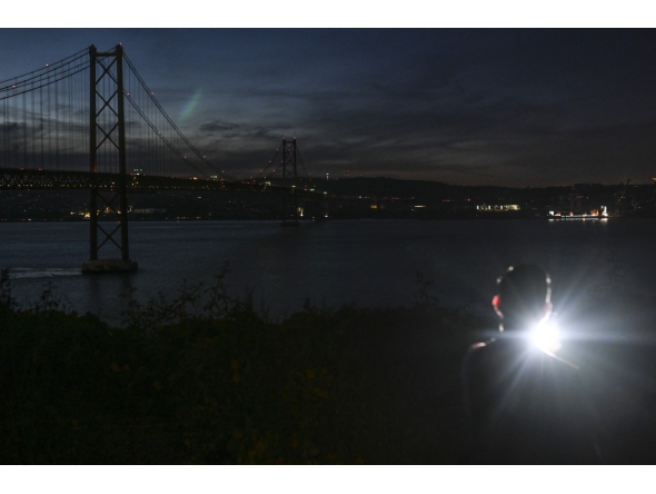 This photograph shows the 25th April bridge over the Tagus river with the lights off following a massive power cut affecting the entire Iberian peninsula and the south of France, in Lisbon on April 28, 2025. Photo by Patricia DE MELO MOREIRA / AFP.

