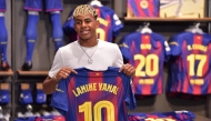Barcelona's Spanish forward Lamine Yamal poses holding his new #10 jersey at the Camp Nou stadium's shop on July 16, 2025 in Barcelona. (Photo by Manaure Quintero / AFP)

