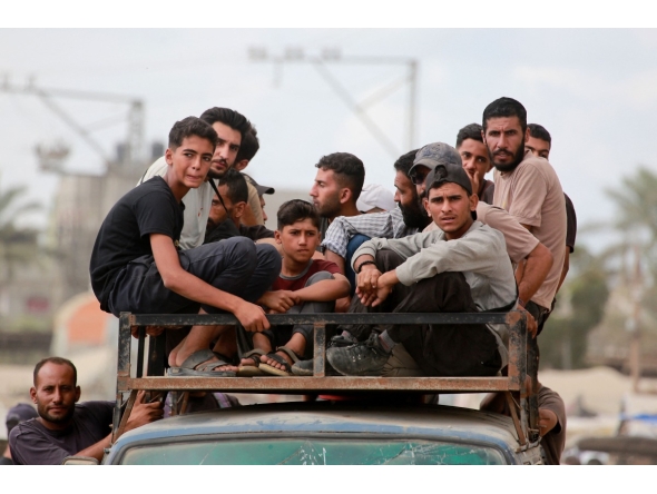 Displaced Palestinians ride a vehicle south of Deir El-Balah in the Central Gaza Strip yesterday.  ( AFP)