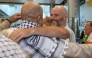 Tadhg Hickey (centre right) one of a group of Irish activists returning, is greeted by supporters as they arrive at Dublin Airport on October 7, 2025, after being deported from Israel. (Photo by Paul Faith / AFP)
