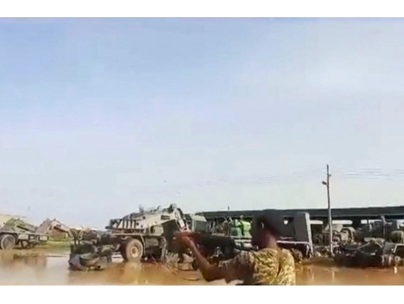 A grab from a UGC video posted on the X platform on August 22, 2023 reportedly shows members of the Sudanese army firing at Rapid Support Forces (RSF) fighters in what they say is the al-Shajara military base in Khartoum. (Photo by UGC / AFP)