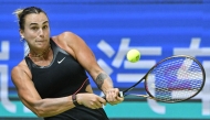 Belarus’ Aryna Sabalenka hits a return to Kazakhstan's Elena Rybakina during their women’s singles quarter-final match at the Wuhan Open tennis tournament in Wuhan, on October 10, 2025. (Photo by Adek Berry / AFP)