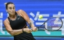 Belarus’ Aryna Sabalenka hits a return to Kazakhstan's Elena Rybakina during their women’s singles quarter-final match at the Wuhan Open tennis tournament in Wuhan, on October 10, 2025. (Photo by Adek Berry / AFP)