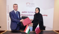 Chairperson of NHRC H E Maryam bint Abdullah Al Attiyah and Commissioner for Human Rights in Tajikistan Umed Bobozod exchanging documents after signing the agreement.