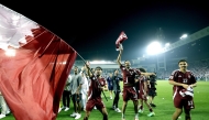 Qatar players celebrate after defeating the United Arab Emirates on Tuesday night to secure their qualification for the FIFA World Cup.
