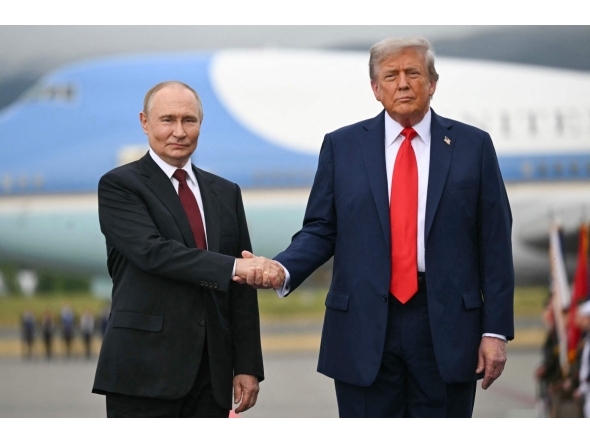 (FILES) US President Donald Trump greets Russian President Vladimir Putin on the tarmac after they arrived at Joint Base Elmendorf-Richardson in Anchorage, Alaska, on August 15, 2025. 