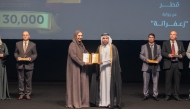 General Manager of the Cultural Village Foundation - Katara Prof. Dr. Khalid bin Ibrahim Al-Sulaiti honouring a winner of the 11th Katara Prize for Arabic Novel 2025 at a ceremony at the Katara Opera House yesterday.