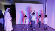 Children enjoy a show at the Light Exhibition.