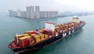 (Files) This aerial view shows a container ship moving towards its berth at the container terminal of the port in Qingdao, in China's eastern Shandong province, on September 24, 2025. (Photo by AFP) 