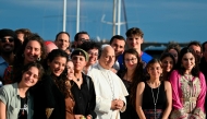 Pope Leo XIV poses with the crew of the Peace training ship 