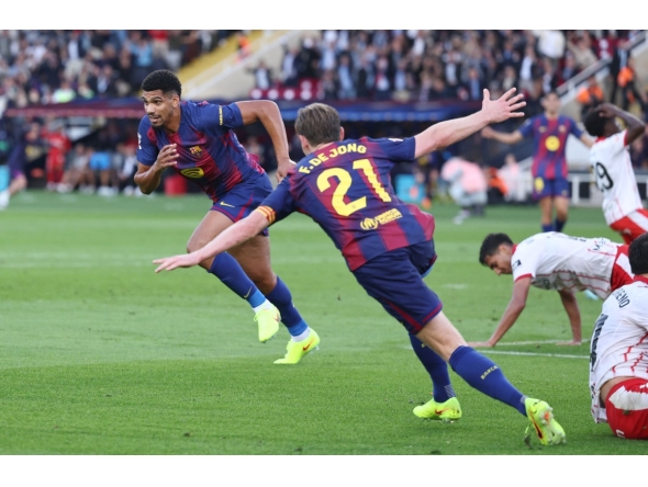Barcelona's Uruguayan defender Ronald Federico Araujo da Silva celebrates scoring his team's second goal during the Spanish league football match between FC Barcelona and Girona FC at Estadi Olimpic Lluis Companys in Barcelona on October 18, 2025. (Photo by Josep LAGO / AFP)