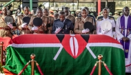 The coffin is carried by officials during the final day of funeral proceedings for Odinga at the Jaramogi Oginga Odinga University grounds in Bondo, on October 19, 2025. (Photo by Luis Tato / AFP)