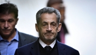 France's former president Nicolas Sarkozy leaves his residence to present himself to La Sante Prison in Paris, on October 21, 2025. Photo by julien de rosa / AFP