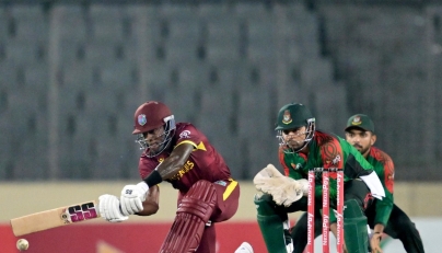 West Indies' Justin Greaves (L) plays a shot during the second one-day international (ODI) cricket match between Bangladesh and West Indies at the Sher-e-Bangla National Cricket Stadium in Dhaka on October 21, 2025. (Photo by Munir UZ ZAMAN / AFP)