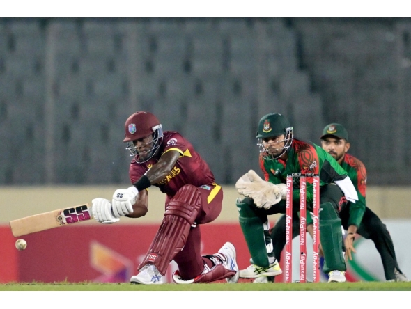 West Indies' Justin Greaves (L) plays a shot during the second one-day international (ODI) cricket match between Bangladesh and West Indies at the Sher-e-Bangla National Cricket Stadium in Dhaka on October 21, 2025. (Photo by Munir UZ ZAMAN / AFP)