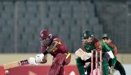 West Indies' Justin Greaves (L) plays a shot during the second one-day international (ODI) cricket match between Bangladesh and West Indies at the Sher-e-Bangla National Cricket Stadium in Dhaka on October 21, 2025. (Photo by Munir UZ ZAMAN / AFP)