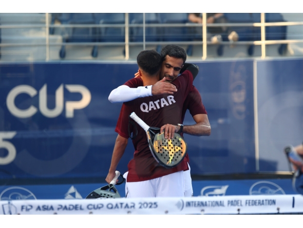 Qatar's Mohammed Saadon Al Kuwari (right) celebrates with a teammate